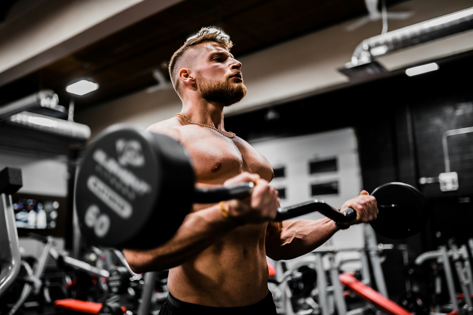 Athlete doing barbell curls